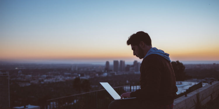 guy working on laptop outside
